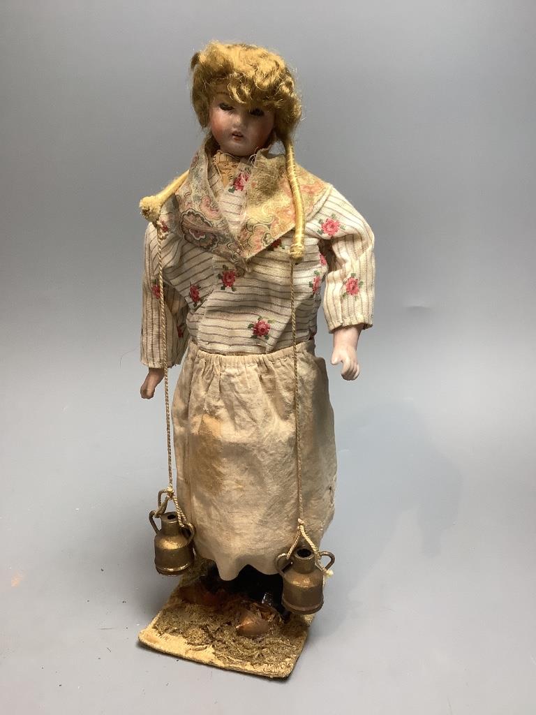 Two costume dolls, one papier mache, the other daisy seller bisque head, both 28cm